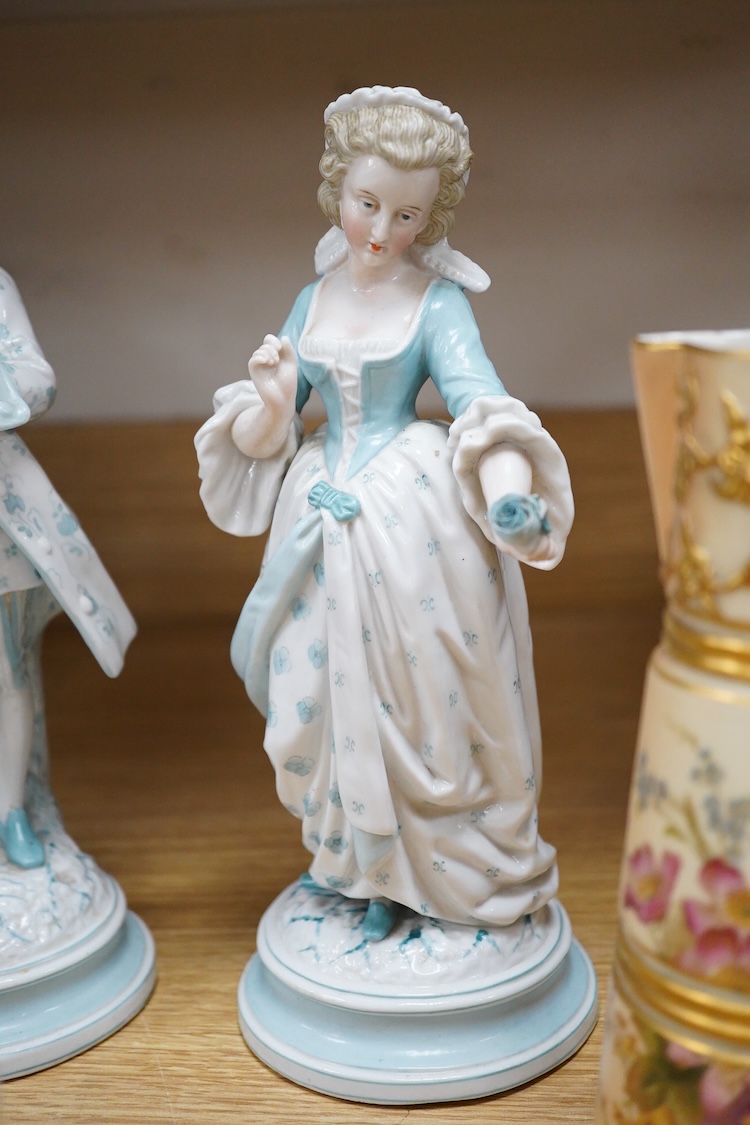Sundry porcelain comprising three German figures, a Royal Worcester blush ivory ewer and a mug, together with a blue wine glass, largest 26cm high